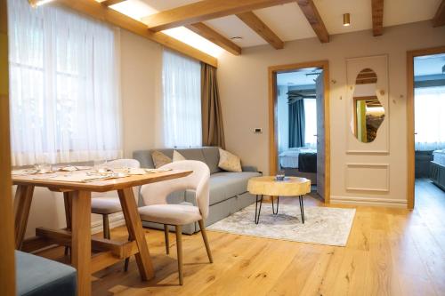 a living room with a couch and a table at Menart Estate in Cerklje na Gorenjskem
