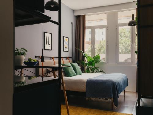 a bedroom with a bed and two windows at Brassbell l DT l Hannaux l Tahrir sq in Cairo
