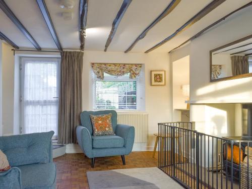 a living room with two chairs and a fireplace at New Cottage in Egton