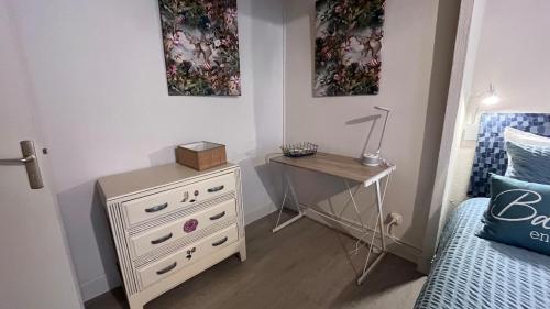 a bedroom with a dresser and a table with a lamp at Superlogis-Studio Le Carré Bleu-Hycentre Blois in Blois