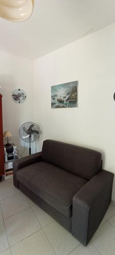 a brown couch sitting in a living room at Casa FLAVIANO in Pizzo