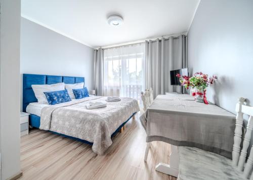 a bedroom with two beds and a window at Pablo in Niechorze