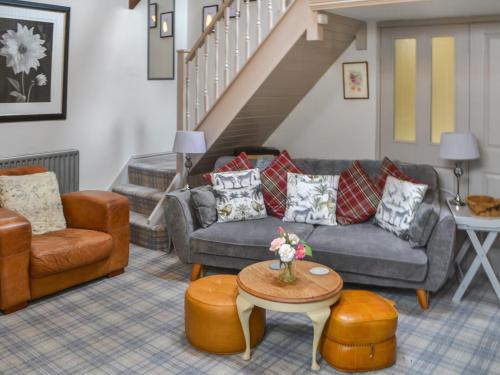 a living room with two couches and a table at The Old Telephone Exchange in Rothbury