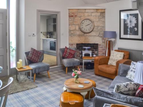 a living room filled with furniture and a fireplace at The Old Telephone Exchange in Rothbury