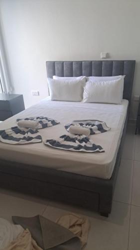 a bed with two pillows on top of it at Modern Cosy Holiday Apartment in Paralimni