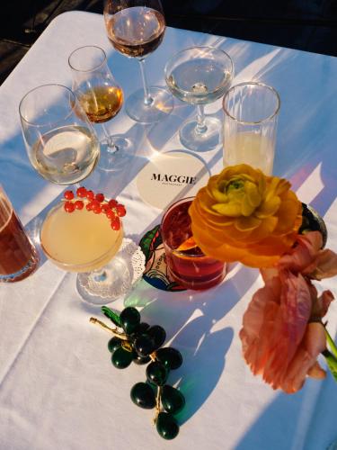 a table with wine glasses and flowers on it at Hotel Rochechouart - Orso Hotels in Paris