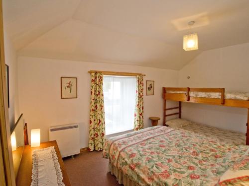 a bedroom with a bunk bed and a window at Chyandaunce in Penzance