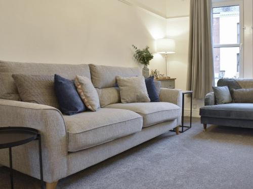 a living room with a couch and a chair at Helvellyn House in Keswick