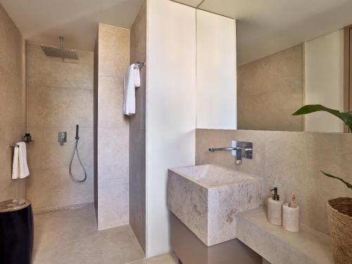 a bathroom with a sink and a shower at Grecotel Astir Palace in Alexandroupoli