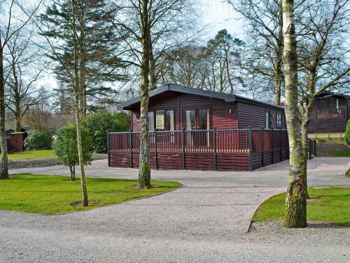 a cabin in a park with trees in front of it at Bransty in Keswick