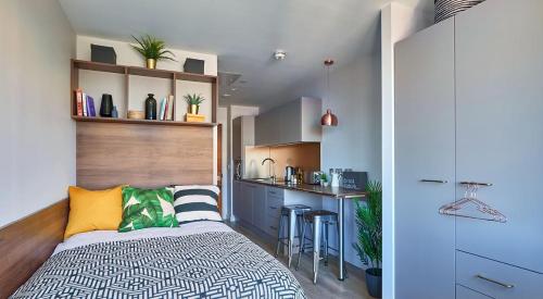 a small bedroom with a bed and a kitchen at For Student Only - Cumberland Place in Southampton in Southampton
