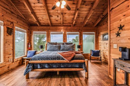 a bedroom with a bed in a log cabin at Grand Mountain View Lodge By Ghosal Luxury Lodging in Sevierville