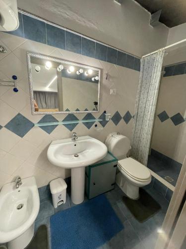 a bathroom with a sink and a toilet and a mirror at Casa vacanze Villa Marta in Porto San Giorgio