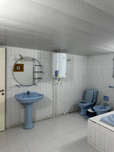 a bathroom with two blue toilets and a sink at Imran Guest House in Samarkand