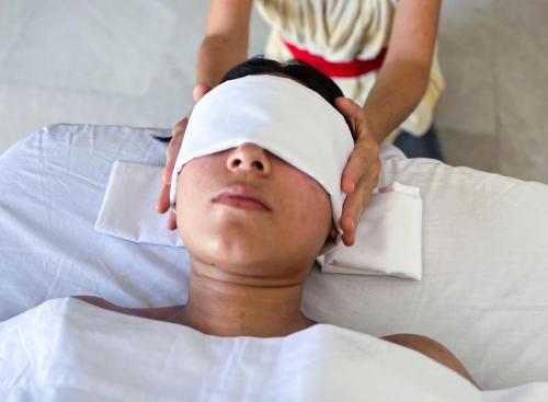 a woman laying on a bed with a bandanna on her head at Hotel La Casa Cielo solo adultos in El Cuyo