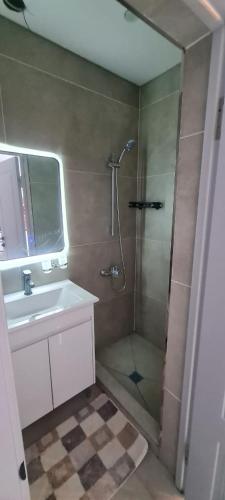 a bathroom with a shower and a sink at ЭКоТУР 125 in Akchiy