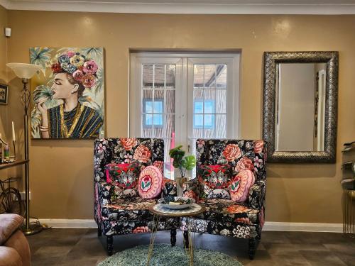 a living room with a couch and a table at Stunning 4 bed house with huge garden and parking in Cheam