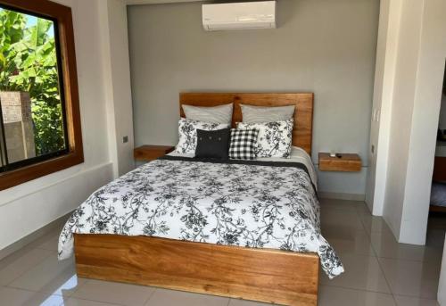 a bedroom with a bed with black and white pillows at Magnalia House 3bd3ba volcano view secure private central in Agua Azul