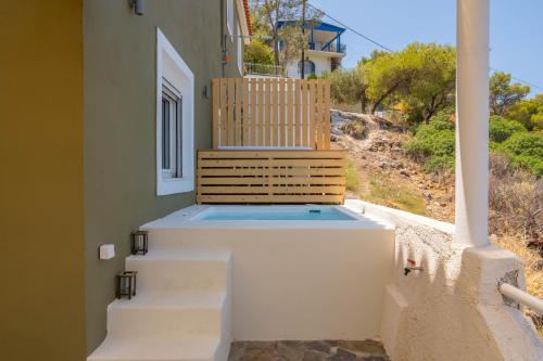 a porch with stairs and a bench on a house at Amelin Villa Paradise in Aegenitissa