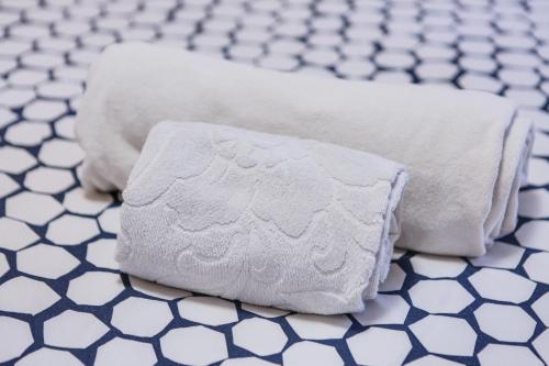two towels are sitting on a tiled floor at Casa March 1 in Moena