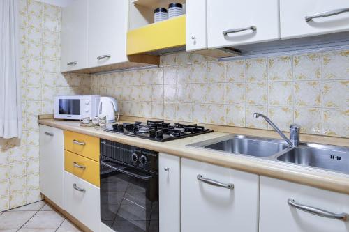 a kitchen with a sink and a stove at Casa March 1 in Moena