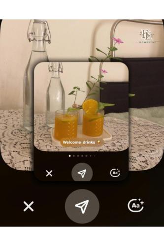 a picture of a bottle and two glasses of orange juice at Bé Homestay in Hai Phong
