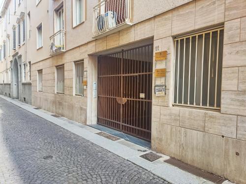 a building with a gate on the side of a street at Casa Marion in Parma