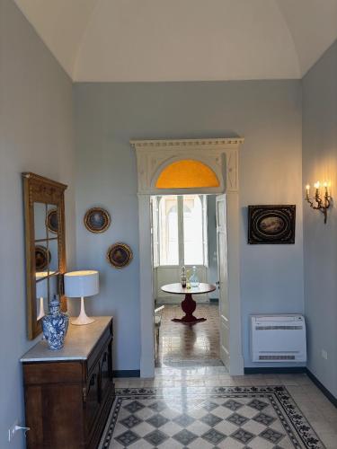 a room with a hallway with a table and a window at Suite Royale Palazzo Villani Lubelli in Cannole