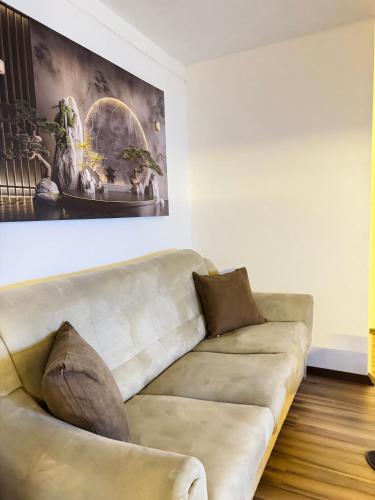 a living room with a couch and a painting on the wall at ANKA APARTMENT in Štip