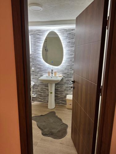 a bathroom with a sink and a mirror at ANKA APARTMENT in Štip