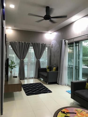 a living room with a couch and a ceiling fan at Fidaiy Homestay in Teronoh
