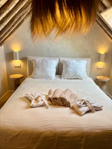a bed with towels and robes on it at Au ptit Gaston in Durbuy