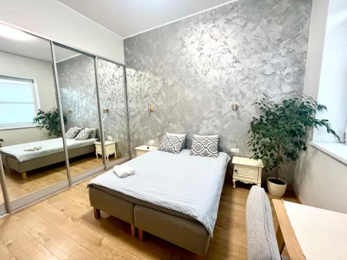 a bedroom with a bed and a couch in a room at New apartment with sauna near Tamula lake in Võru