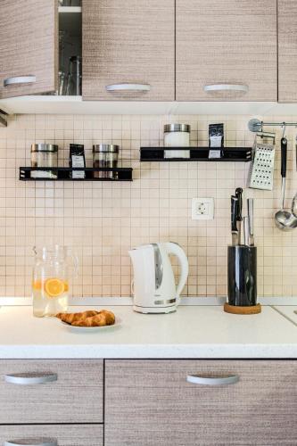 a kitchen counter with a coffee maker and a plate of food at Holiday Home Sarbunara in Milna