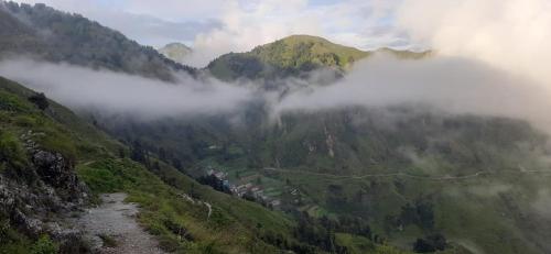 a view of a mountain with clouds in the valley at DS Residency Homestay, Chakrata in Chakrāta
