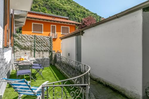 Un balcón con una mesa y sillas en el césped en L' angolino di Cannobio - Happy Rentals, en Cannobio