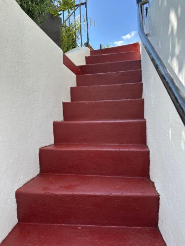 a set of red stairs with a hand railing at The Coal Vaults in Brighton & Hove