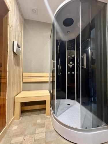 a shower stall with a bench in a bathroom at Villa Veranda in Smolyan