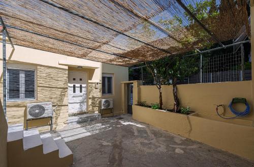 a patio with a pergola on the side of a house at Alex Apartments in Preveza