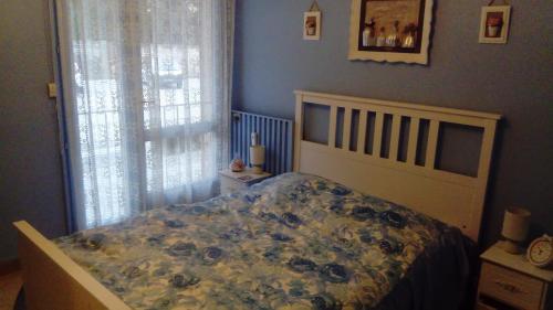 une chambre avec un lit avec un couvre-lit fleuri dans l'établissement agréable appartement 3 pièces 62 m2, à Hyères