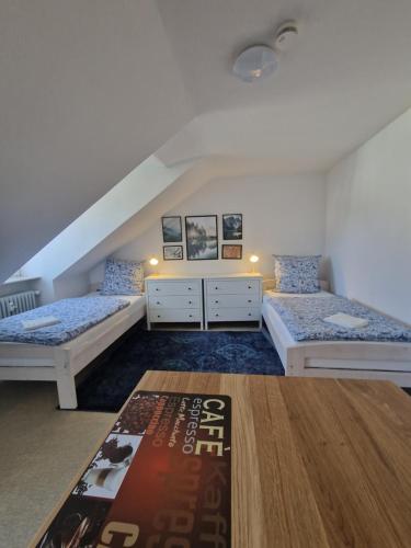 a bedroom with two beds and a book on the floor at Residencia del Pueblo II in Pirk