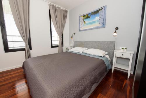 a bedroom with a bed and two windows at Villa Simon2 in Veliko Brdo