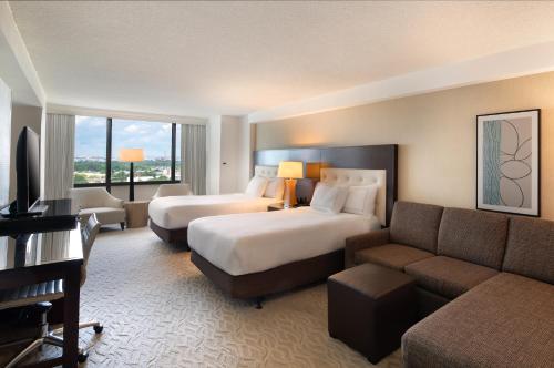a hotel room with a bed and a couch at DoubleTree by Hilton Washington DC – Crystal City in Arlington