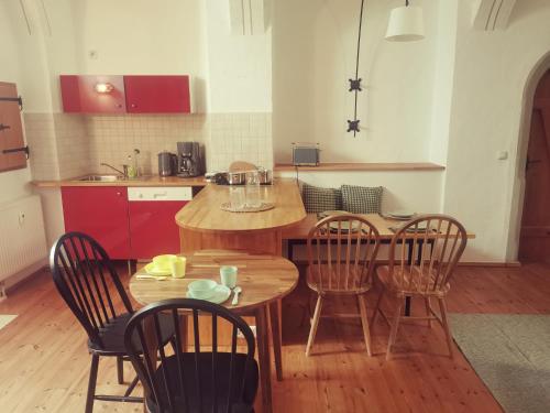 a kitchen with a wooden table and chairs and a table and a kitchen at Bergmanns Lieblingsplatz in Freiberg