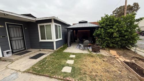 a house with a porch with a table and chairs at Little Bettys Cottage in Torrance