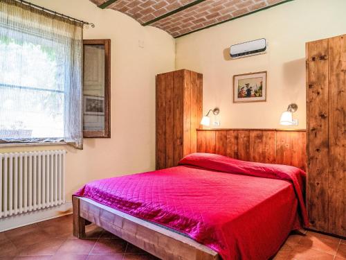 a bedroom with a bed with a red bedspread at Apartment Bomba vista lago 8 by Interhome in Villa Santa Maria