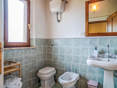 a bathroom with a toilet and a sink at Apartment Bomba vista lago 8 by Interhome in Villa Santa Maria