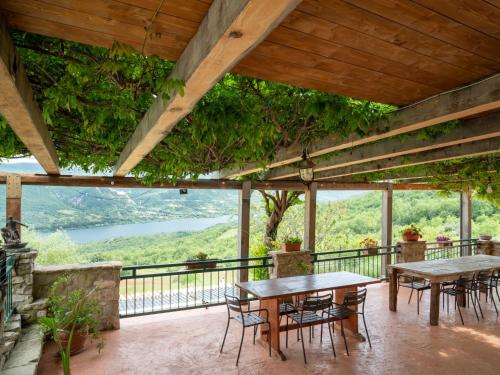 a patio with tables and chairs and a view at Apartment Bomba vista lago 8 by Interhome in Villa Santa Maria