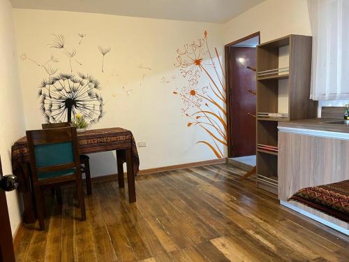 a dining room with a table and a wall at Casa Antade Cusco in Cusco