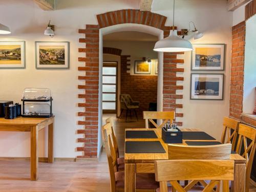 a dining room with a table and chairs at Penzion Festung in Petrovice